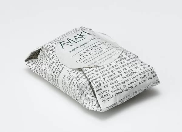 Image of a singe olive oil soap wrapped in newspaper by Avlaki