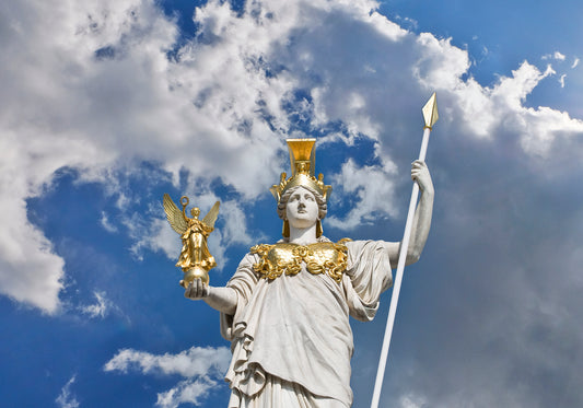 A statue of Athena with gold details, holding a spear