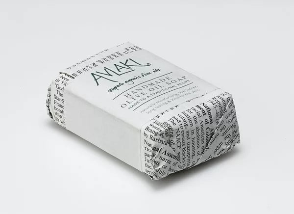 Image of a single Avlaki olive oil soap bar wrapped in newspaper